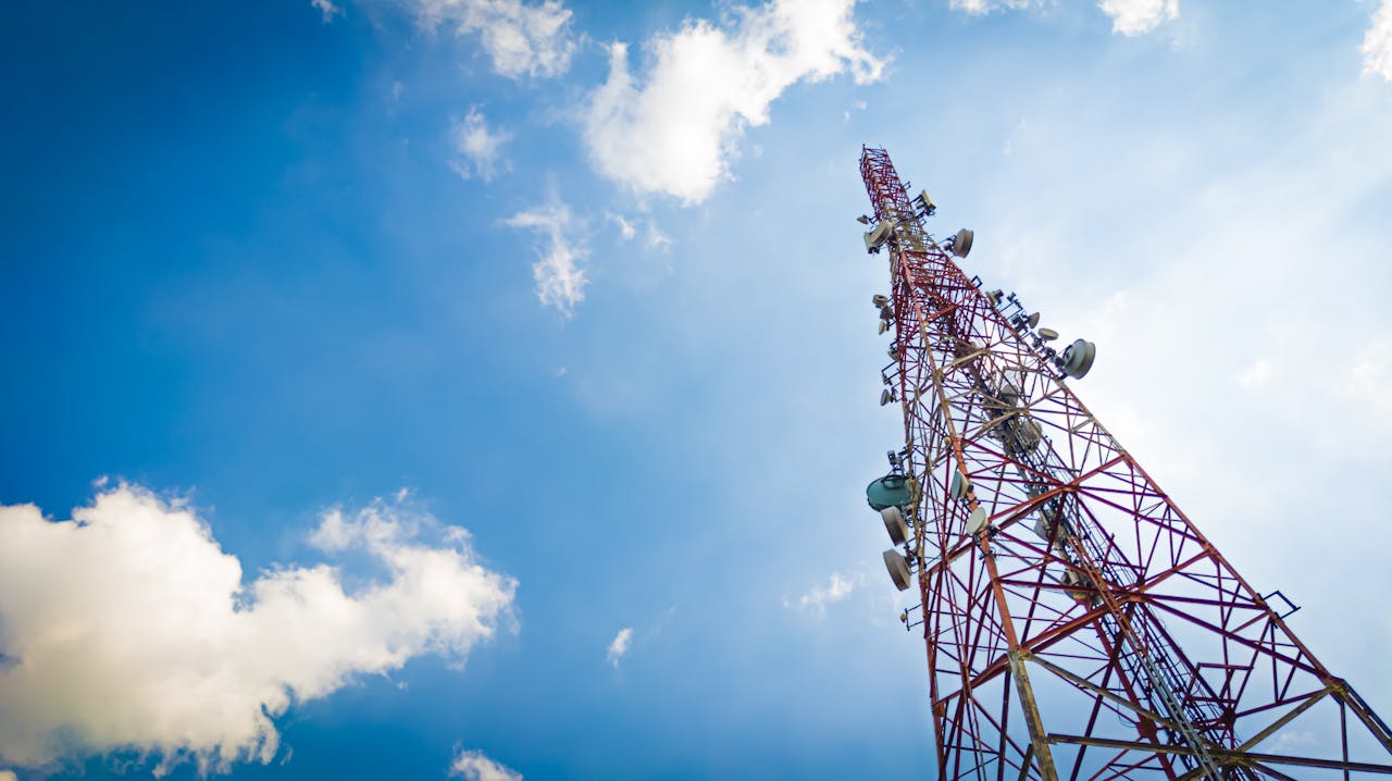 View of a tall telecom tower set against a clear blue sky in Depok, Indonesia.